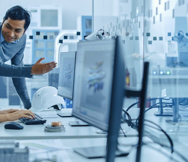 two people reviewing data at a computer