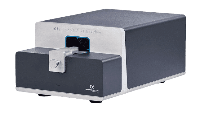 A compact, black and silver device labeled "disperGRADER αview" from Alpha Technologies, used for analyzing material dispersion with a sleek design and precision sample insertion mechanism.
